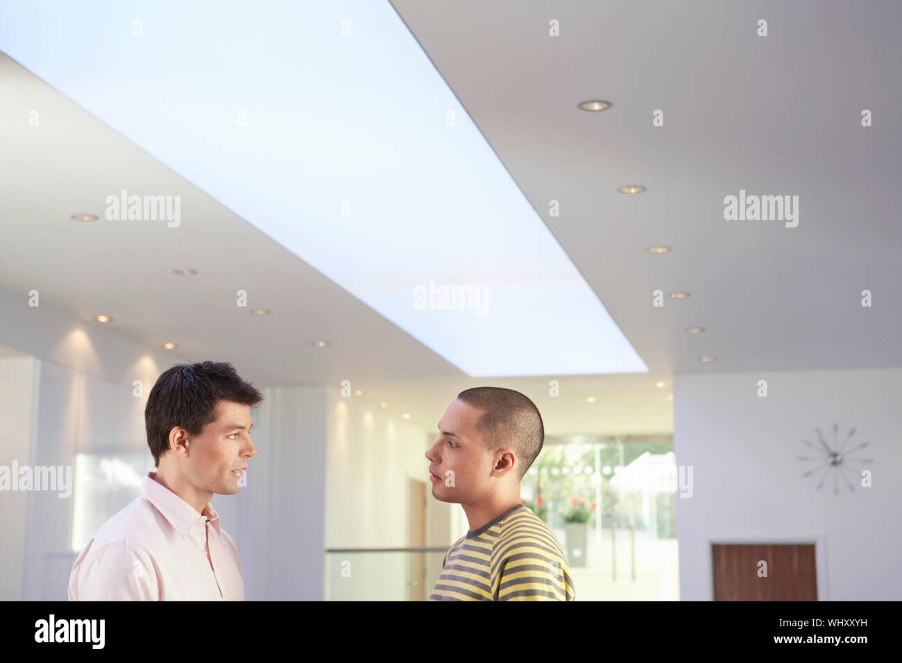 Side view of two multiethnic businessmen talking in the office Stock ...