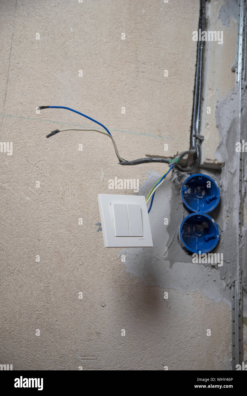 Replacing the electrical outlet in the wall of the house Stock Photo