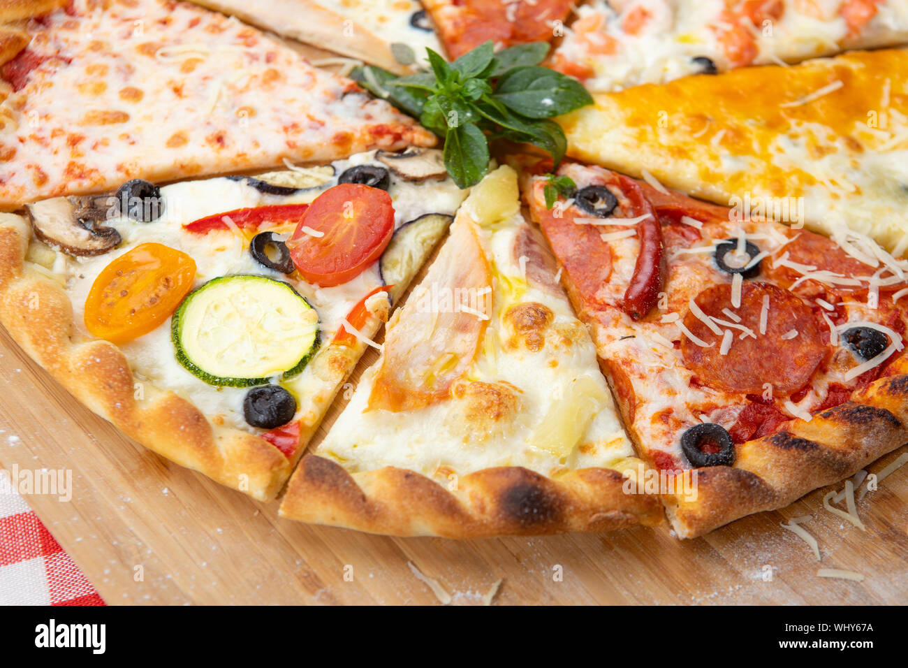 Assorted pizza slices closeup with different ingredients decorated