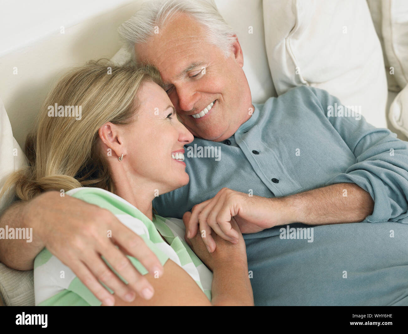 Old couple embracing in bed hi-res stock photography and images - Alamy