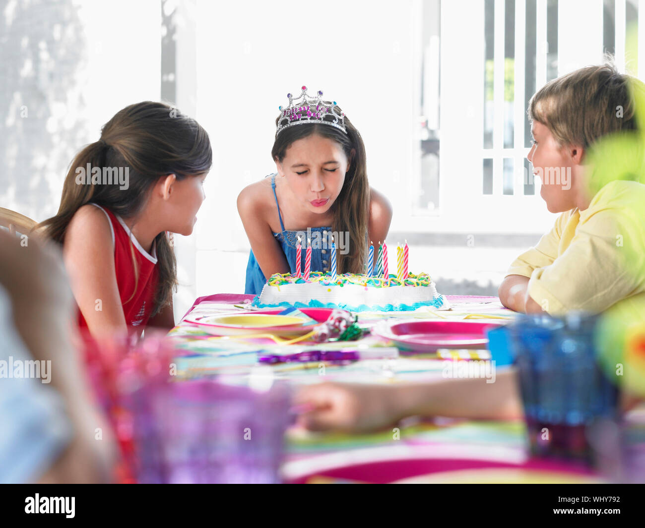 Girl blowing out birthday candles at the outdoor party Stock Photo - Alamy