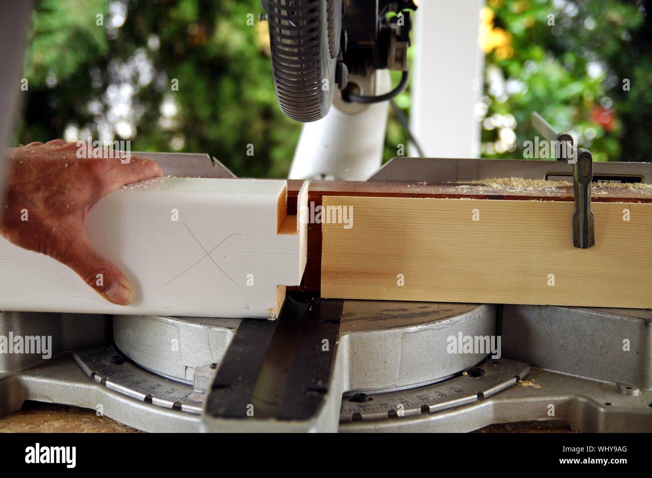 Carpenter Using A Circular Saw To Cut A Wooden Beam - 