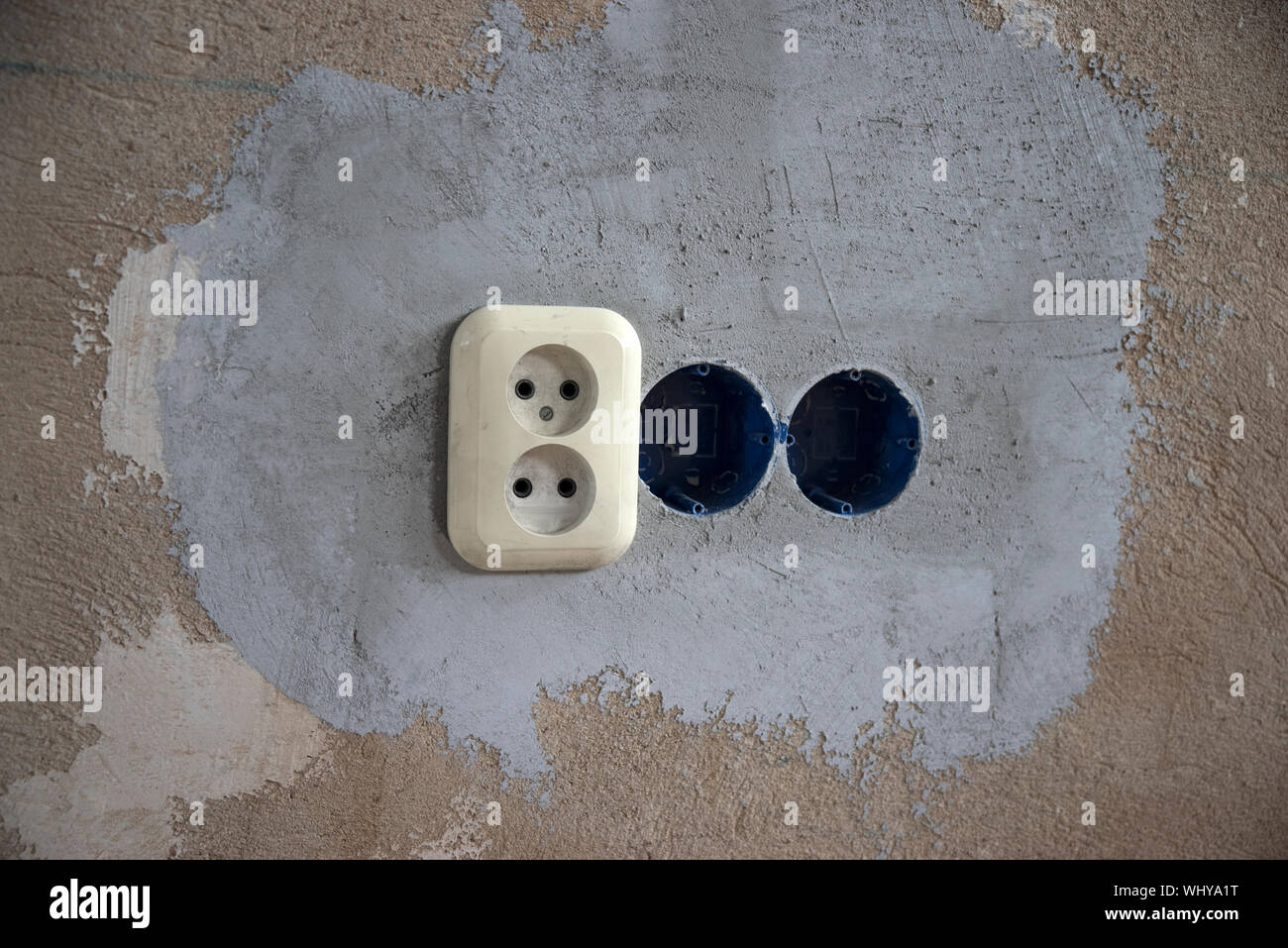 Replacing the electrical outlet in the wall of the house Stock Photo