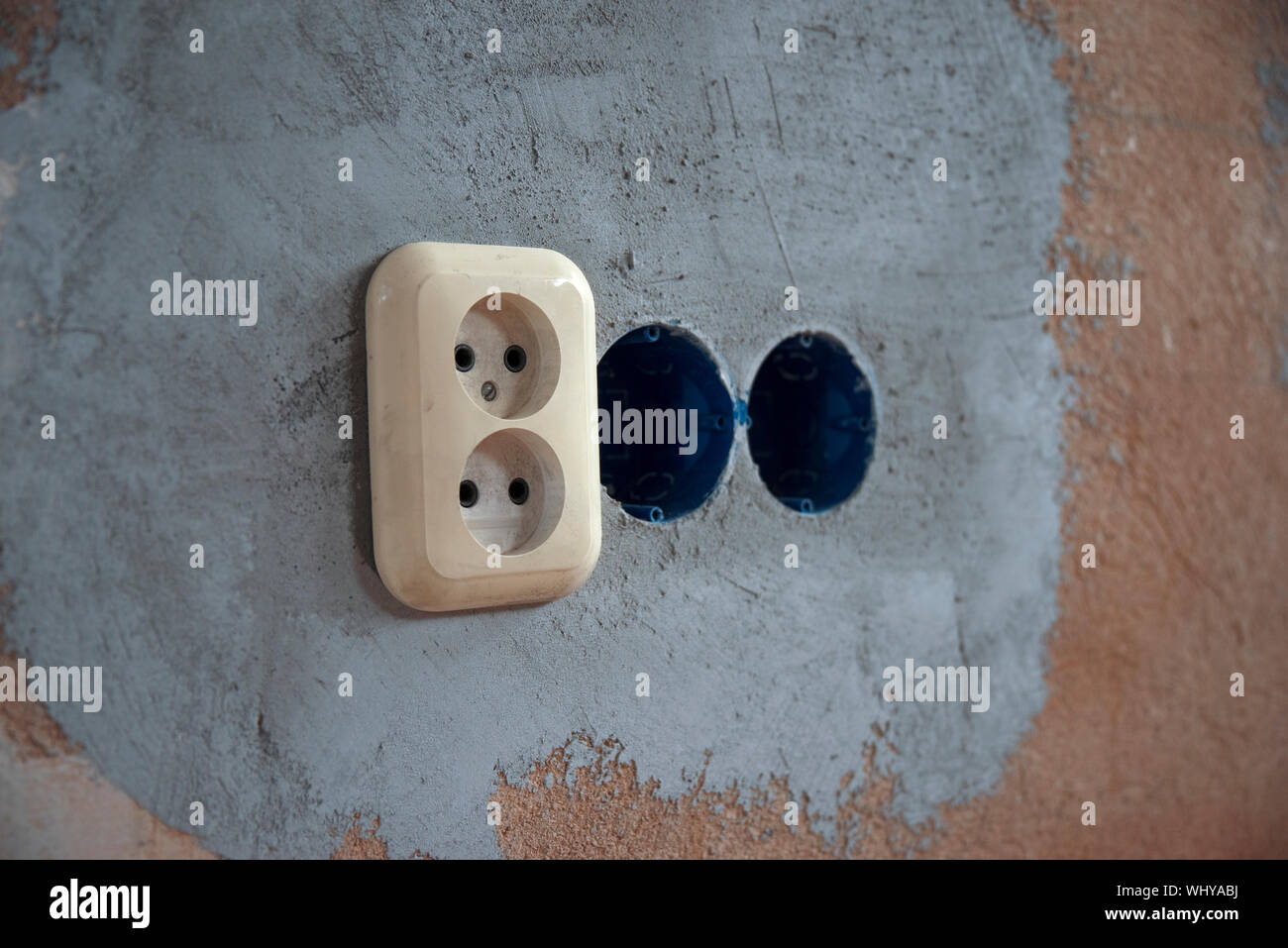 Replacing the electrical outlet in the wall of the house Stock Photo