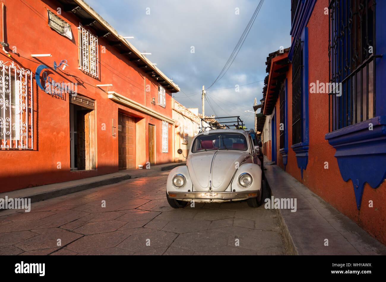 Street in San Cristobal de las Casas old town with old Volkswagen Beetle, Chiapas, Mexico. Stock Photo