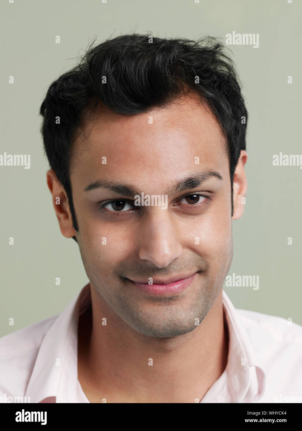 Closeup Portrait Of Happy Young Asian Man On Colored Background
