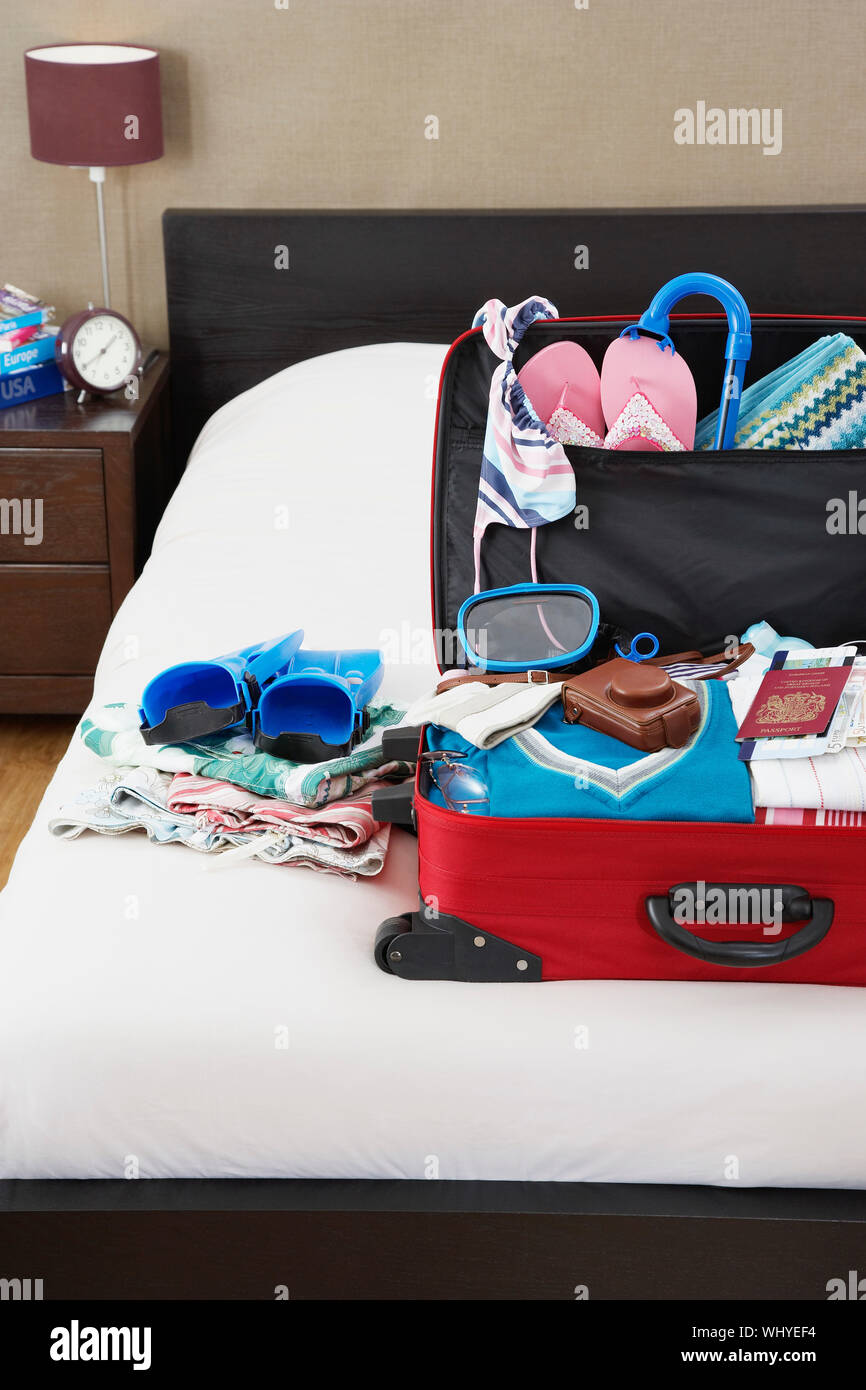 Open suitcase on bed elevated view Stock Photo Alamy