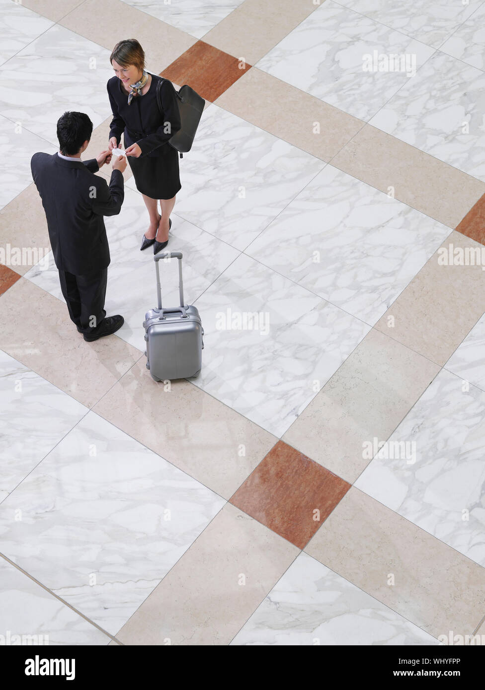 Elevated View Of A Businessman Presenting Business Card To