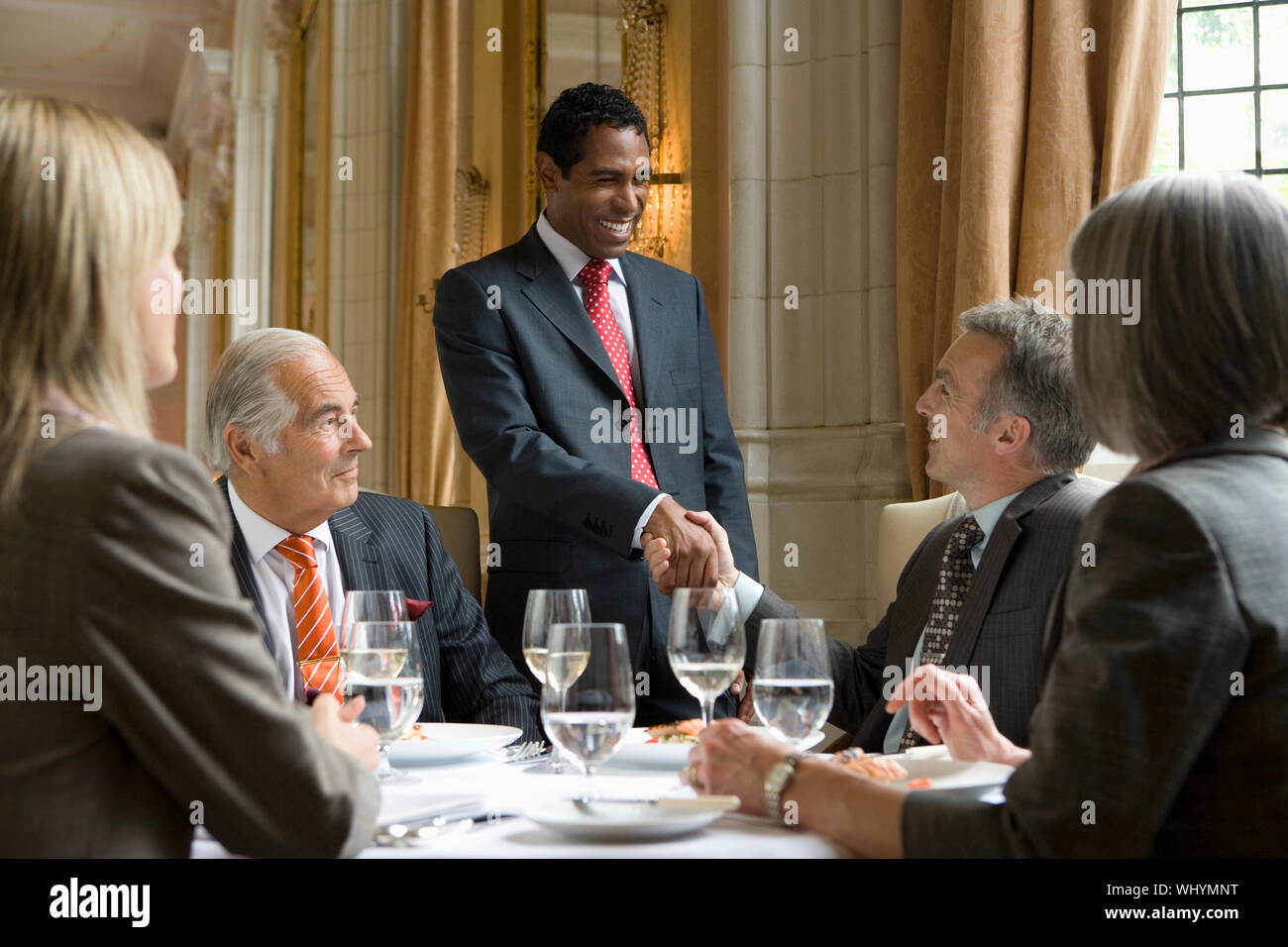 Happy businesspeople in meeting at the restaurant table Stock Photo