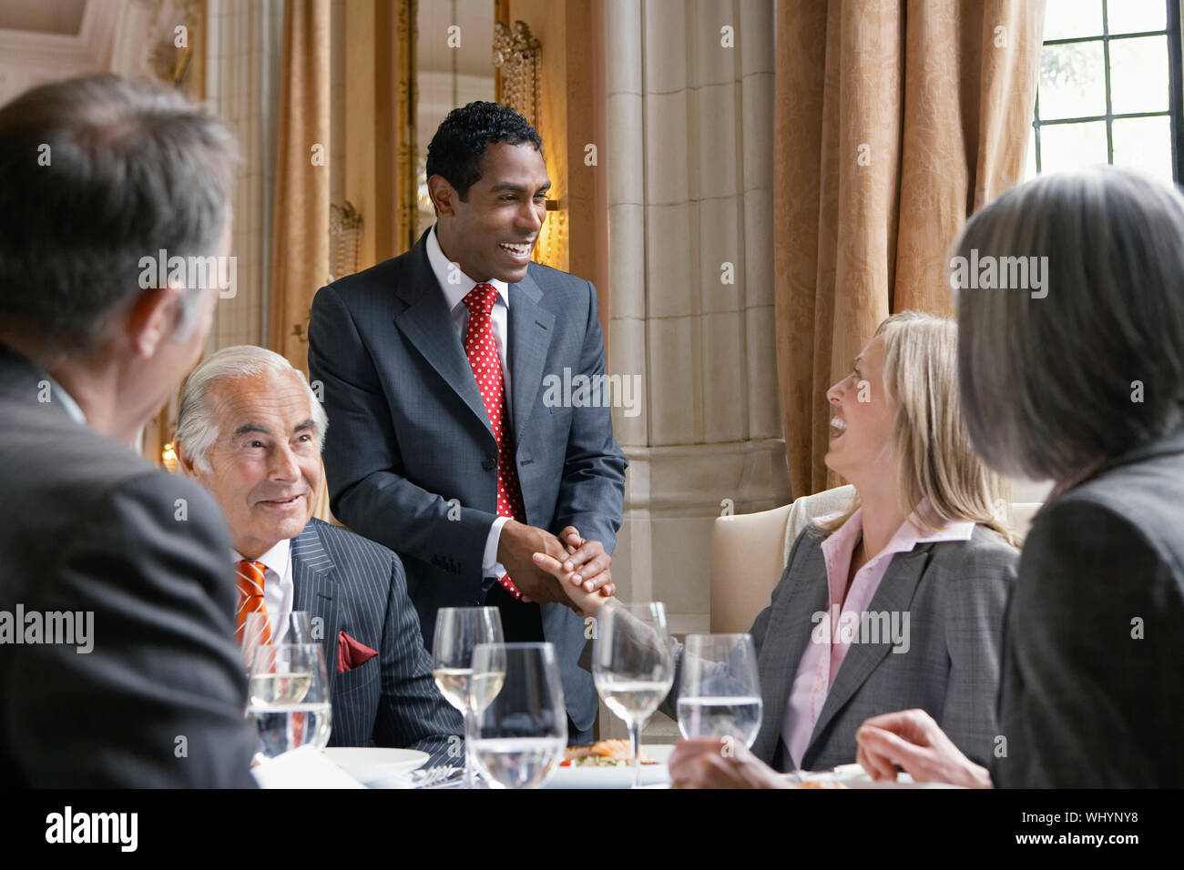 Happy businesspeople in meeting at the restaurant table Stock Photo