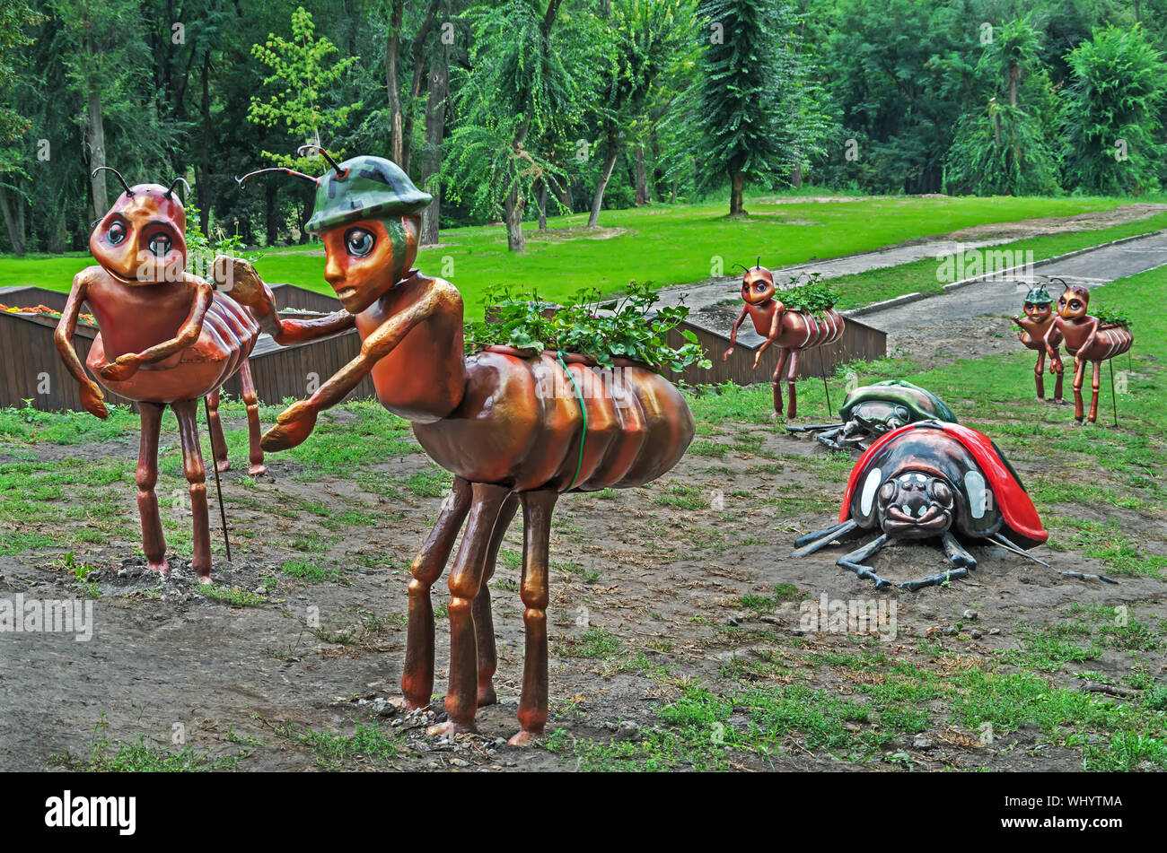 Sculpture of beetles and ants installed in a clearing under the trees as decoration in the city amusement park Stock Photo