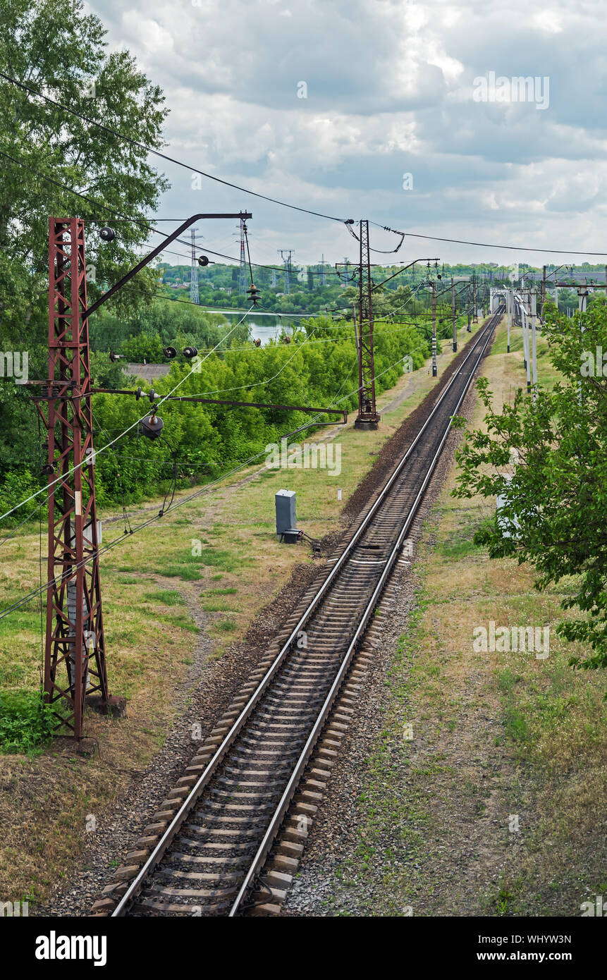 Top view of the electrified railway line that goes to bridge over the