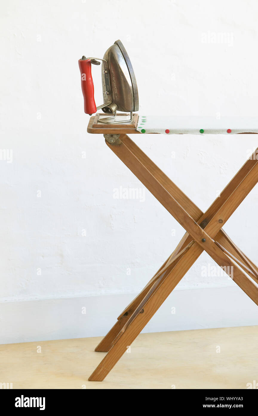 Iron on ironing board Stock Photo Alamy