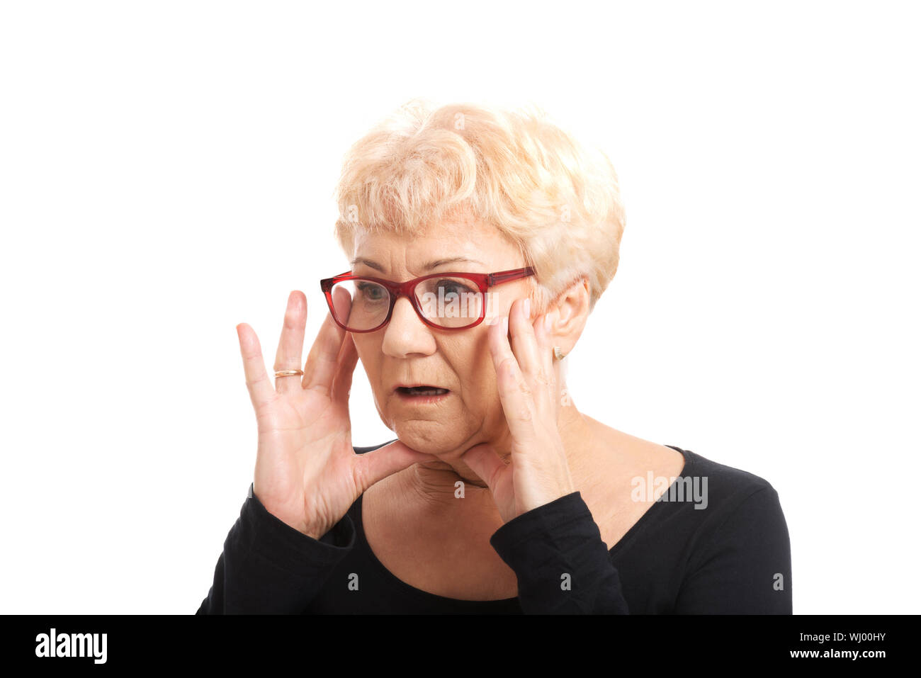 An old lady expresses shock surprise. Isolated on white Stock