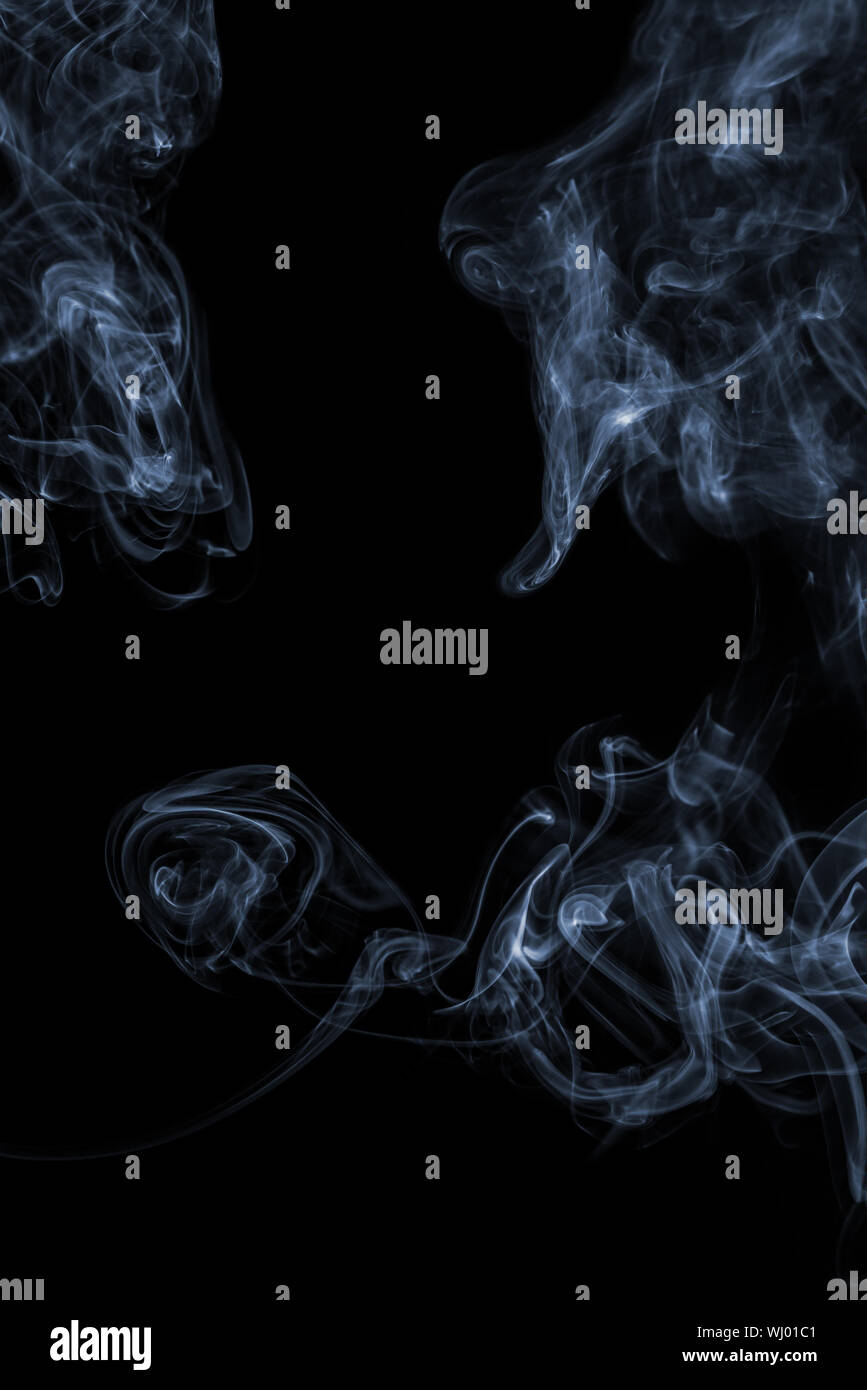 Blue smoke on a black background Stock Photo - Alamy