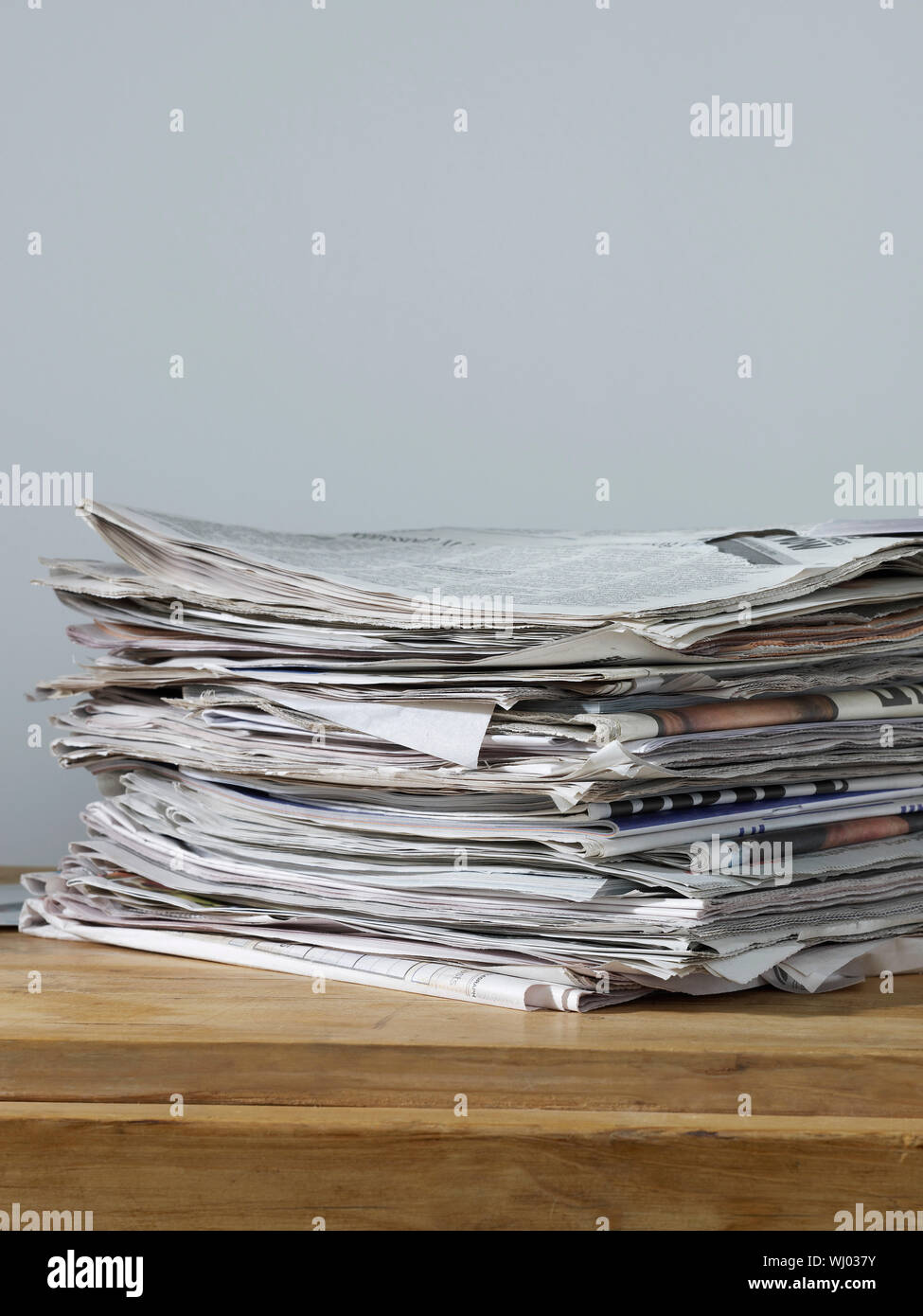 Stack of newspapers on table Stock Photo
