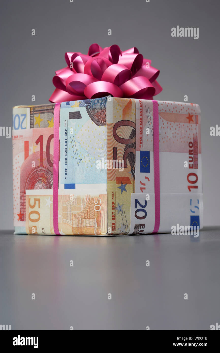 Small gift wrapped in Euro notes Stock Photo - Alamy