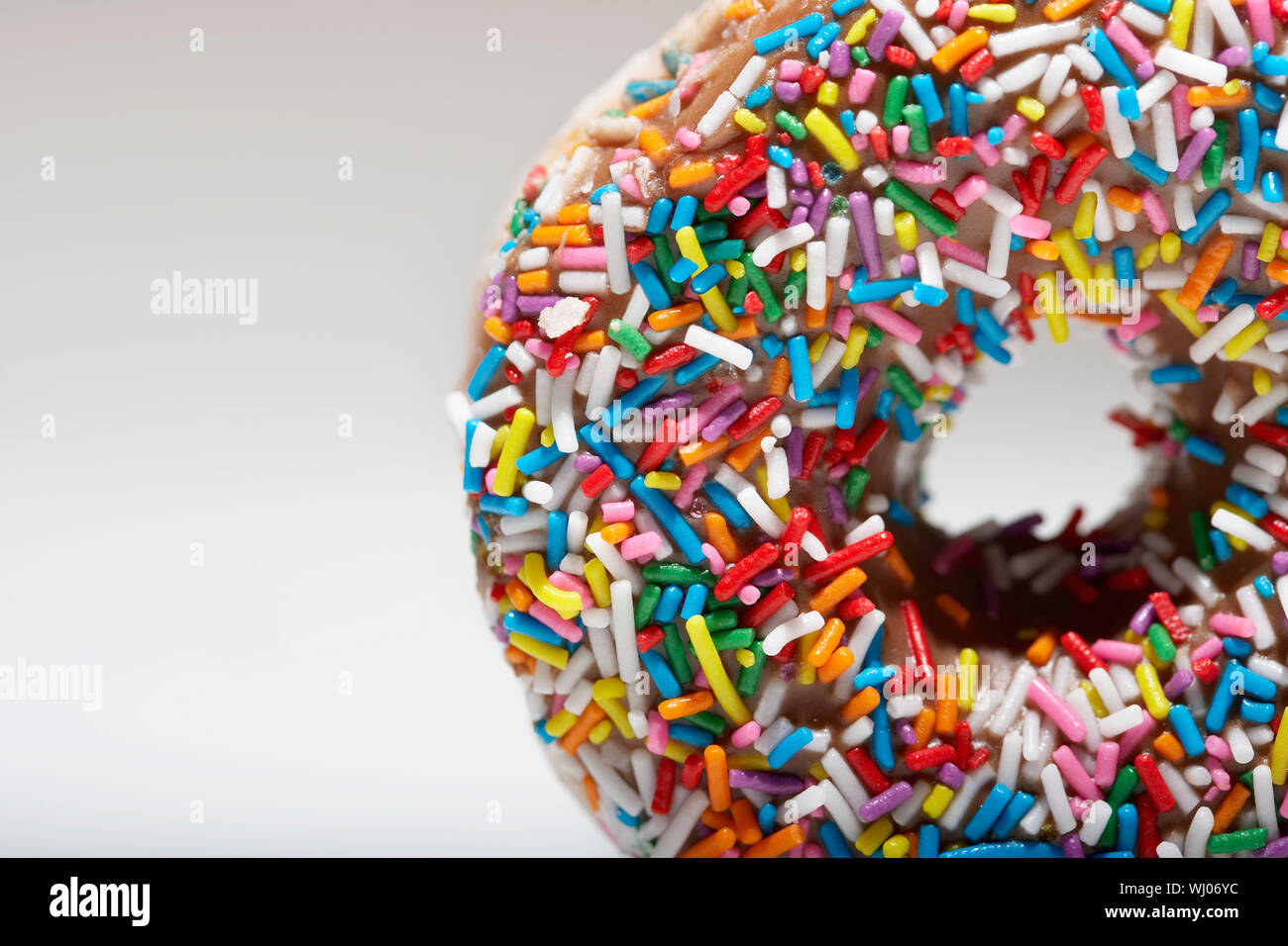 Rainbow sprinkles on doughnut Stock Photo