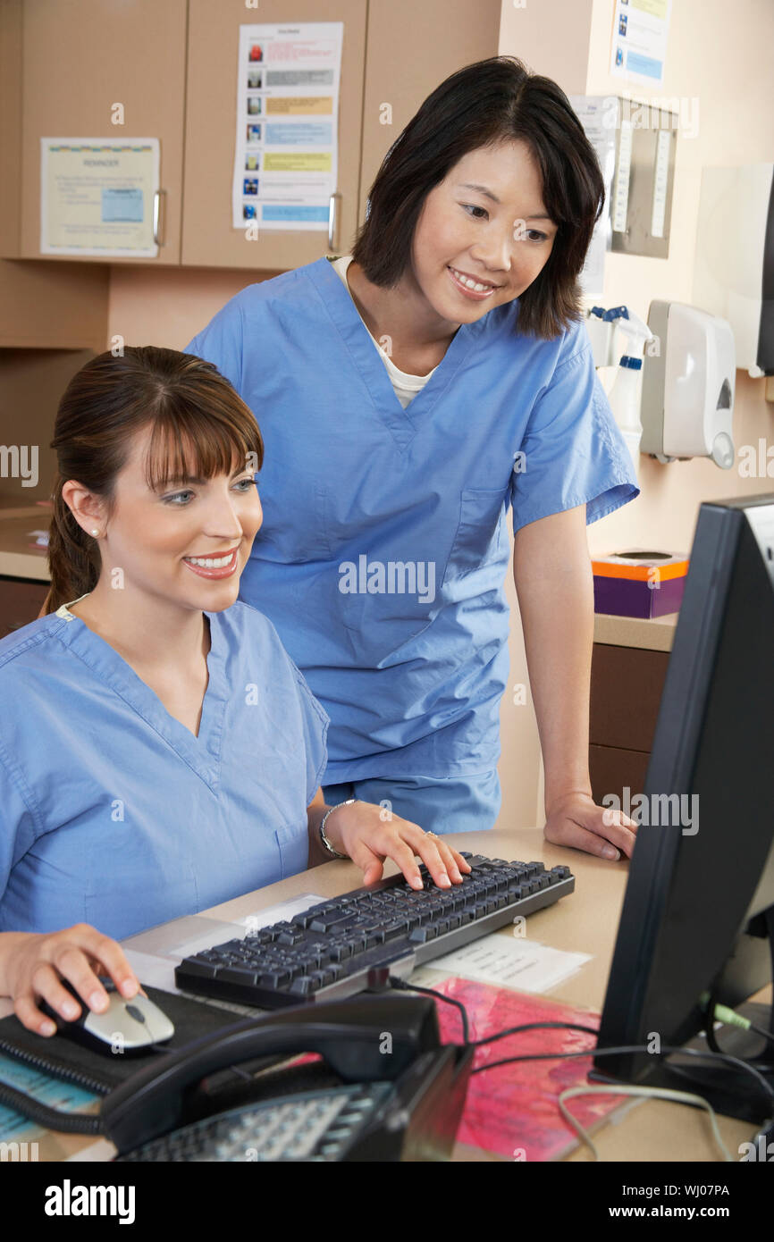 Two female nurses working on computer in doctor's office Stock Photo
