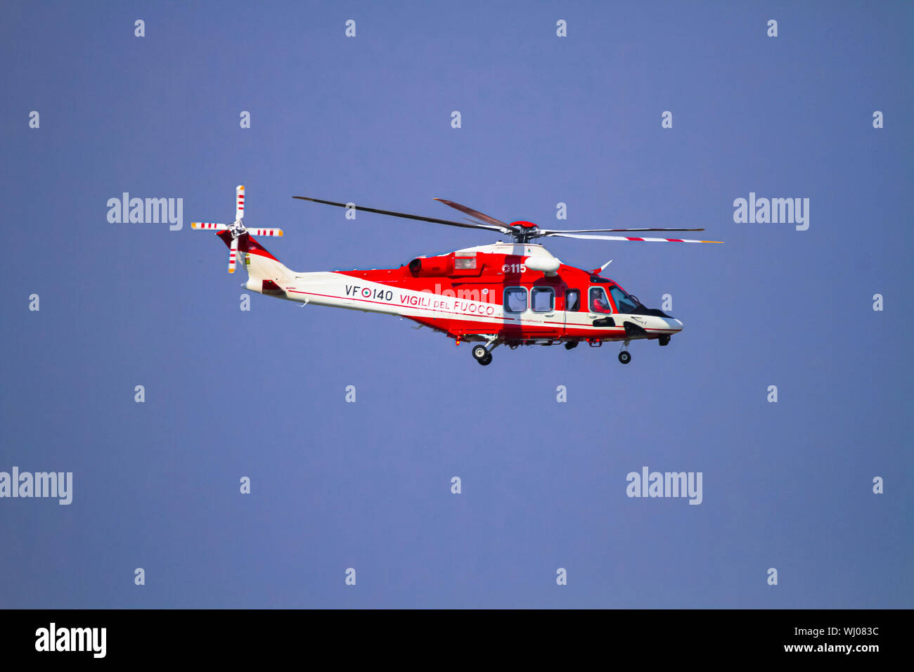 Fire fighter's helicopter AgustaWestland AW139 (VF-140) in flight Photographed in Malpensa, Milan, Italy Stock Photo