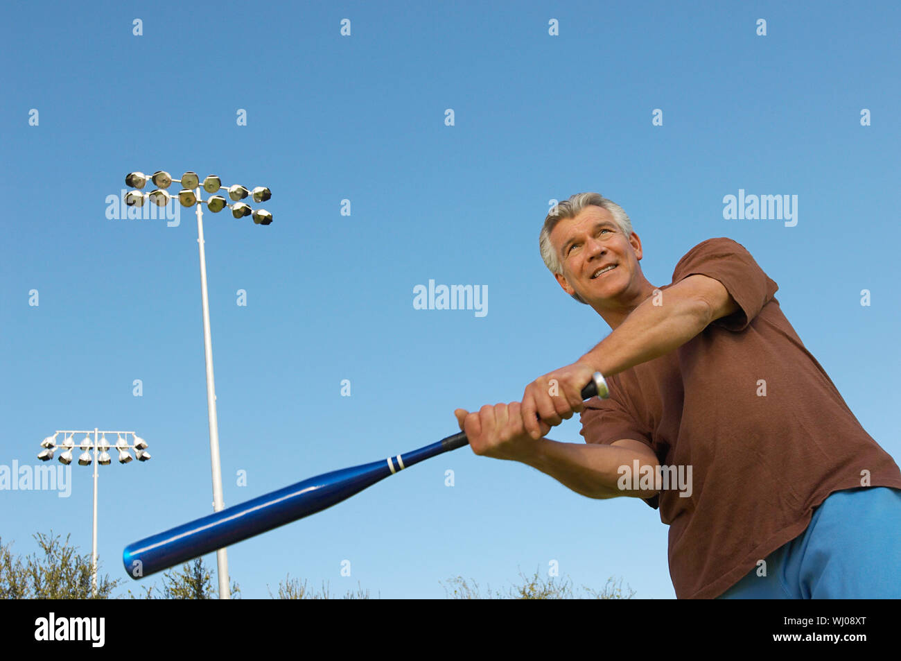 Senior man swinging baseball bat Stock Photo Alamy