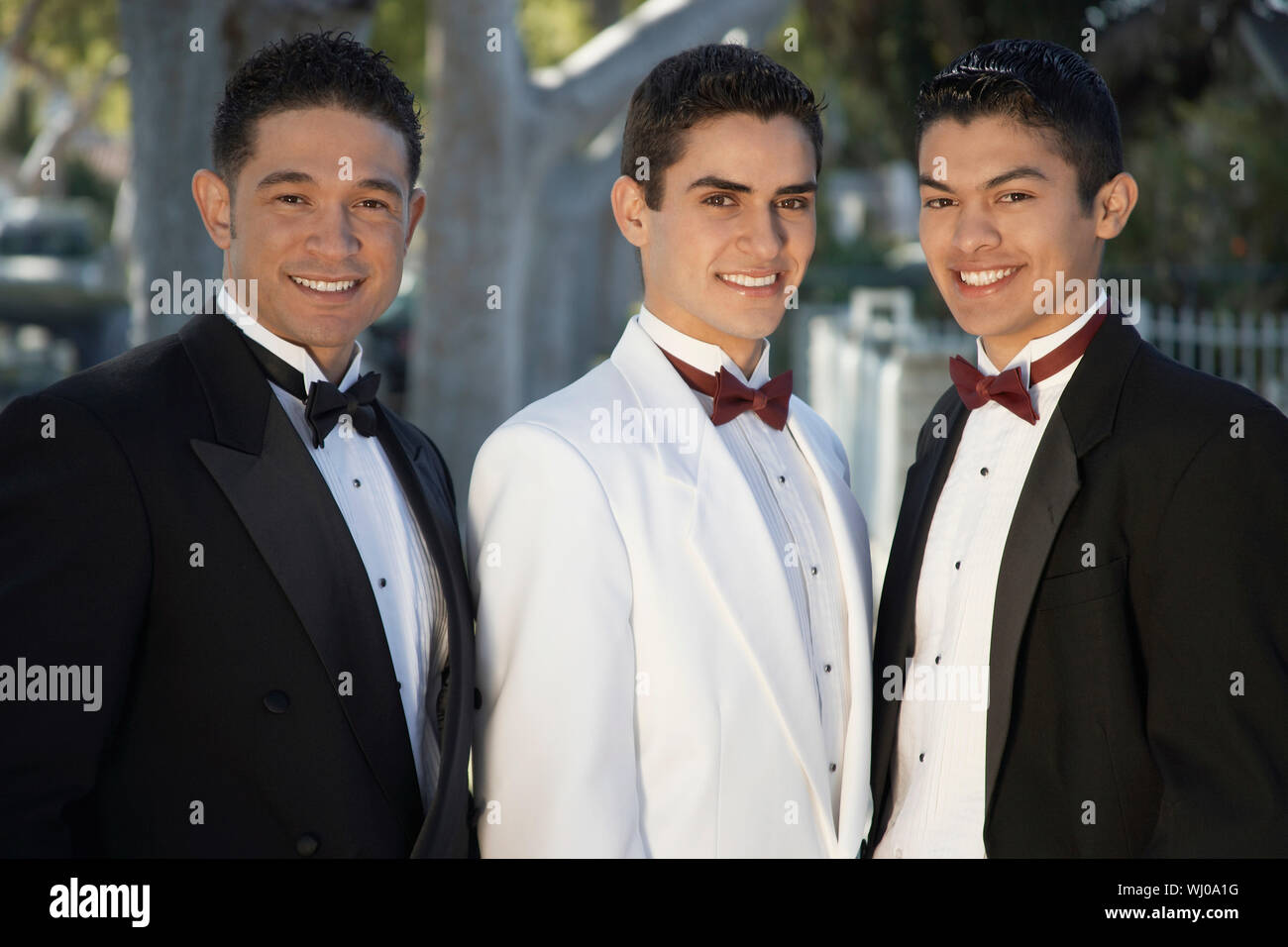 Portrait of three men wearing tuxedos outdoors Stock Photo
