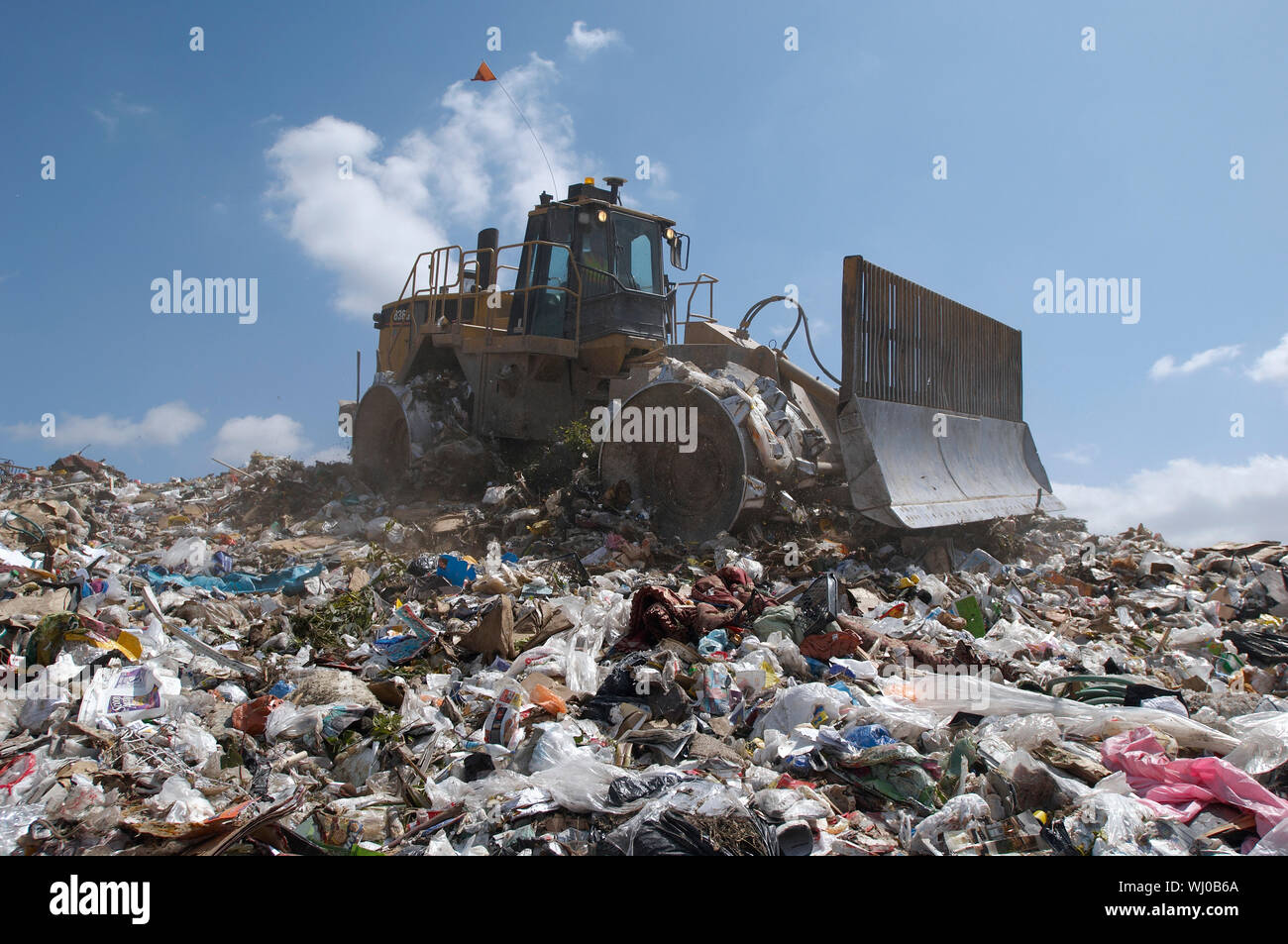 Digger working at landfill site Stock Photo - Alamy