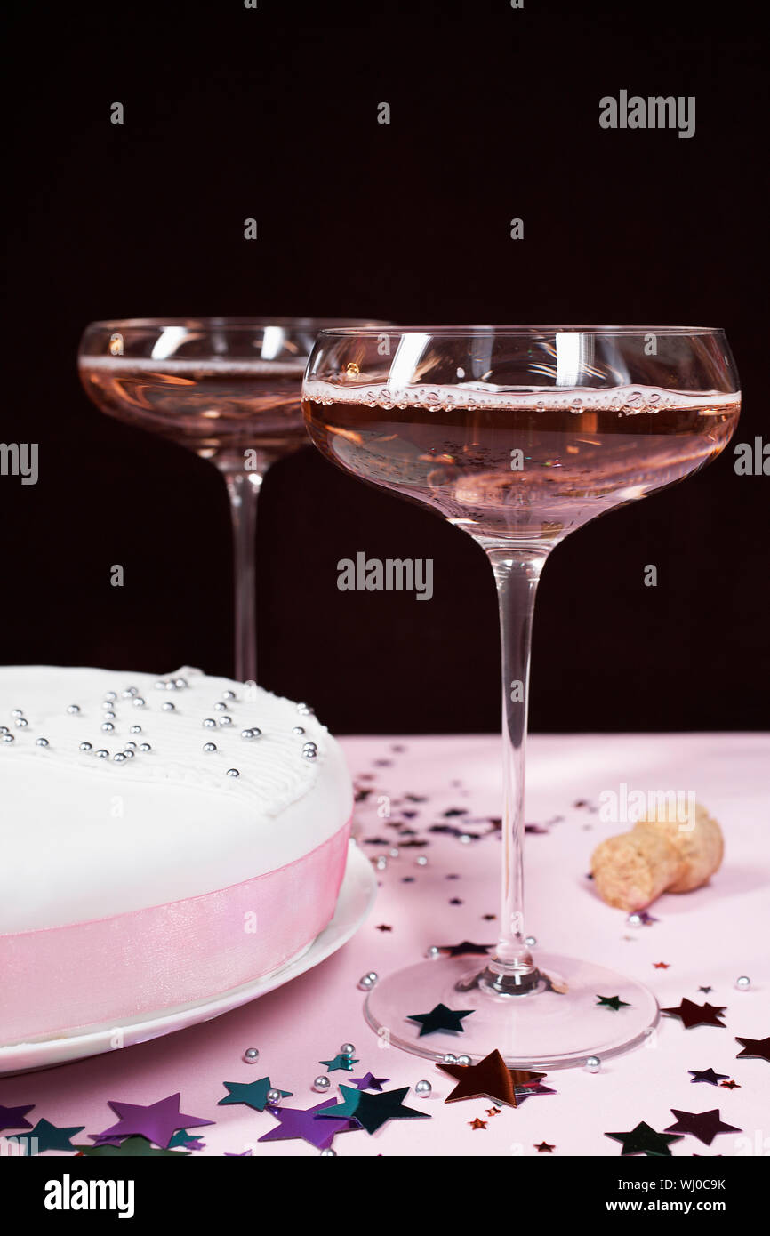 Two champagne glasses and cake, close up Stock Photo