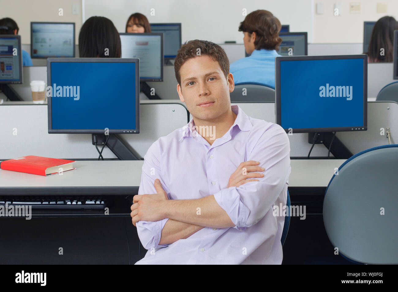 Male student sitting in computer classroom, portrait Stock Photo - Alamy