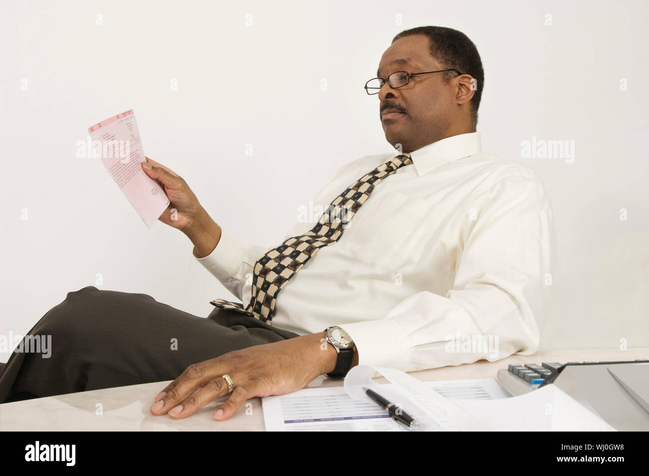 An African American Financial Advisor With Document At Desk In