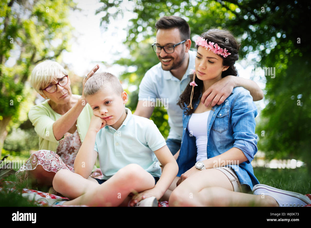 Family consoling little stubborn child and managing emotions Stock Photo