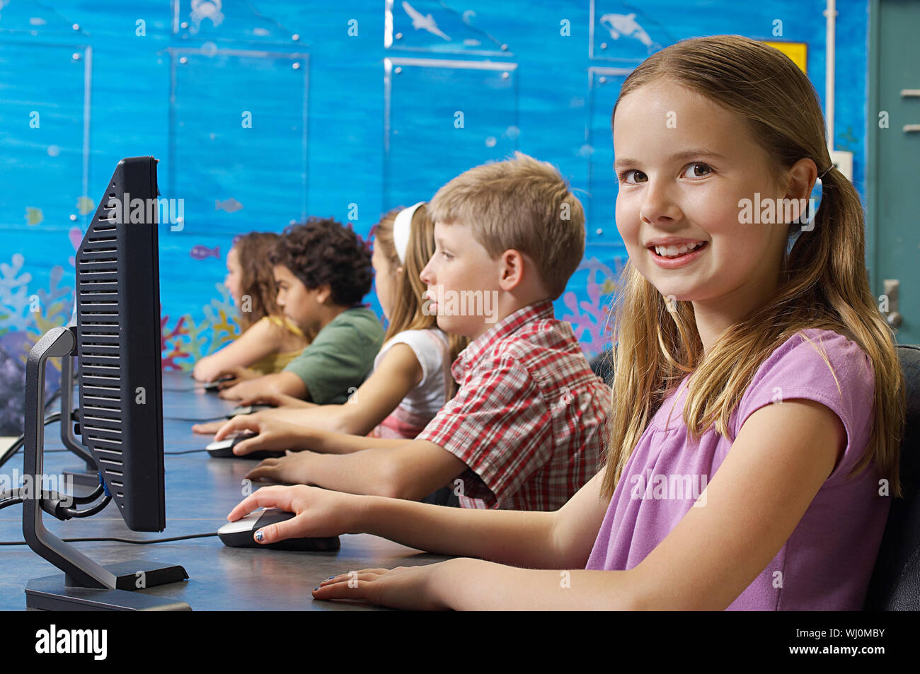 School children using computers in classroom Stock Photo - Alamy