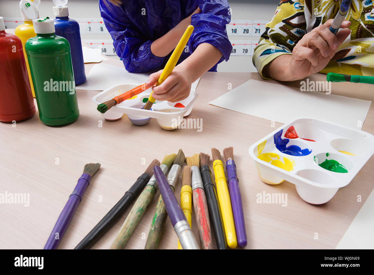 Female student with teacher in art class Stock Photo - Alamy