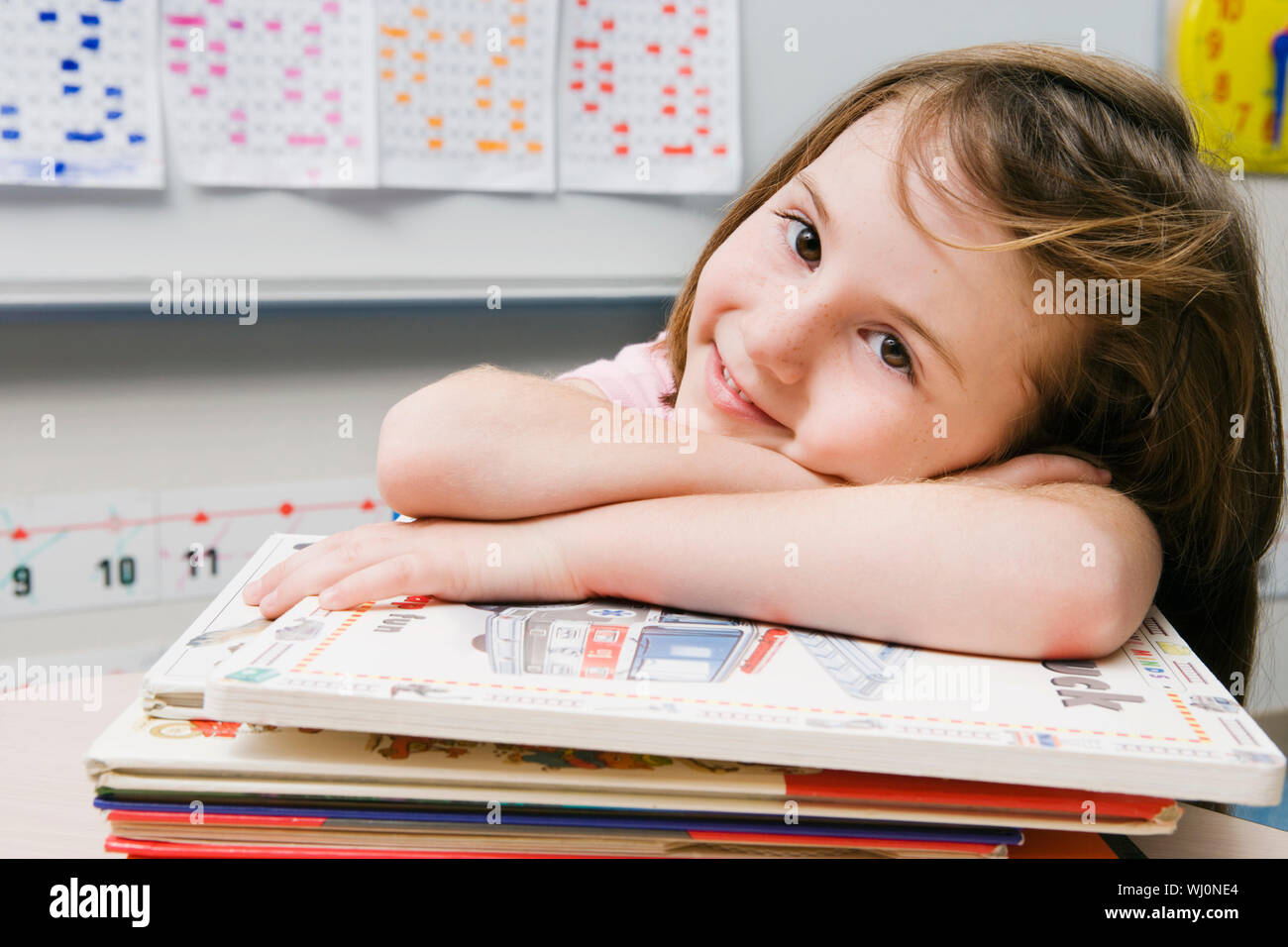 Little Girl with a Stack of Books Stock Photo - Alamy