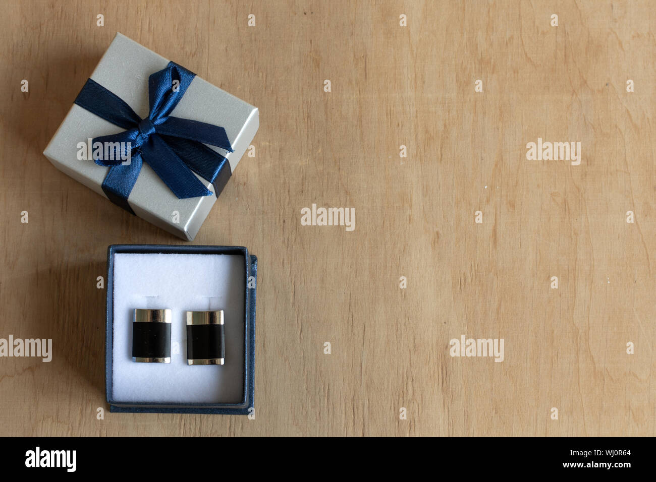 Pair Of Cufflinks In A Gift Box On Wooden Background Copy Space Mockup For Design Stock Photo Alamy