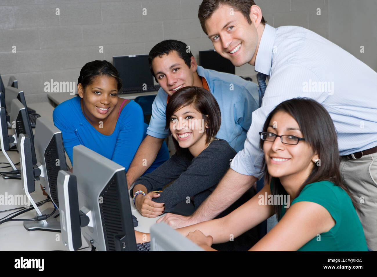 Portrait of happy students with professor in computer laboratory Stock ...