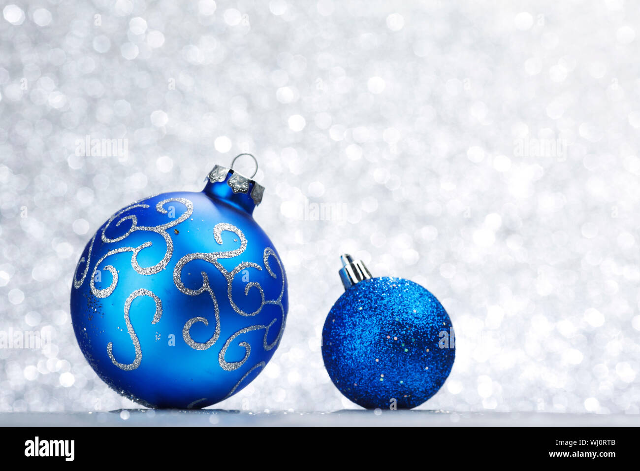 Blue shiny christmas balls on silver glitter background Stock Photo Alamy