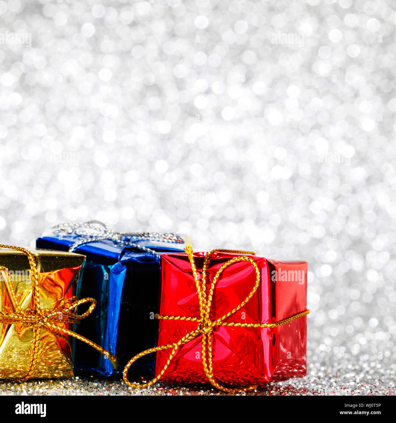 Gift boxes on glitter silver background Stock Photo - Alamy
