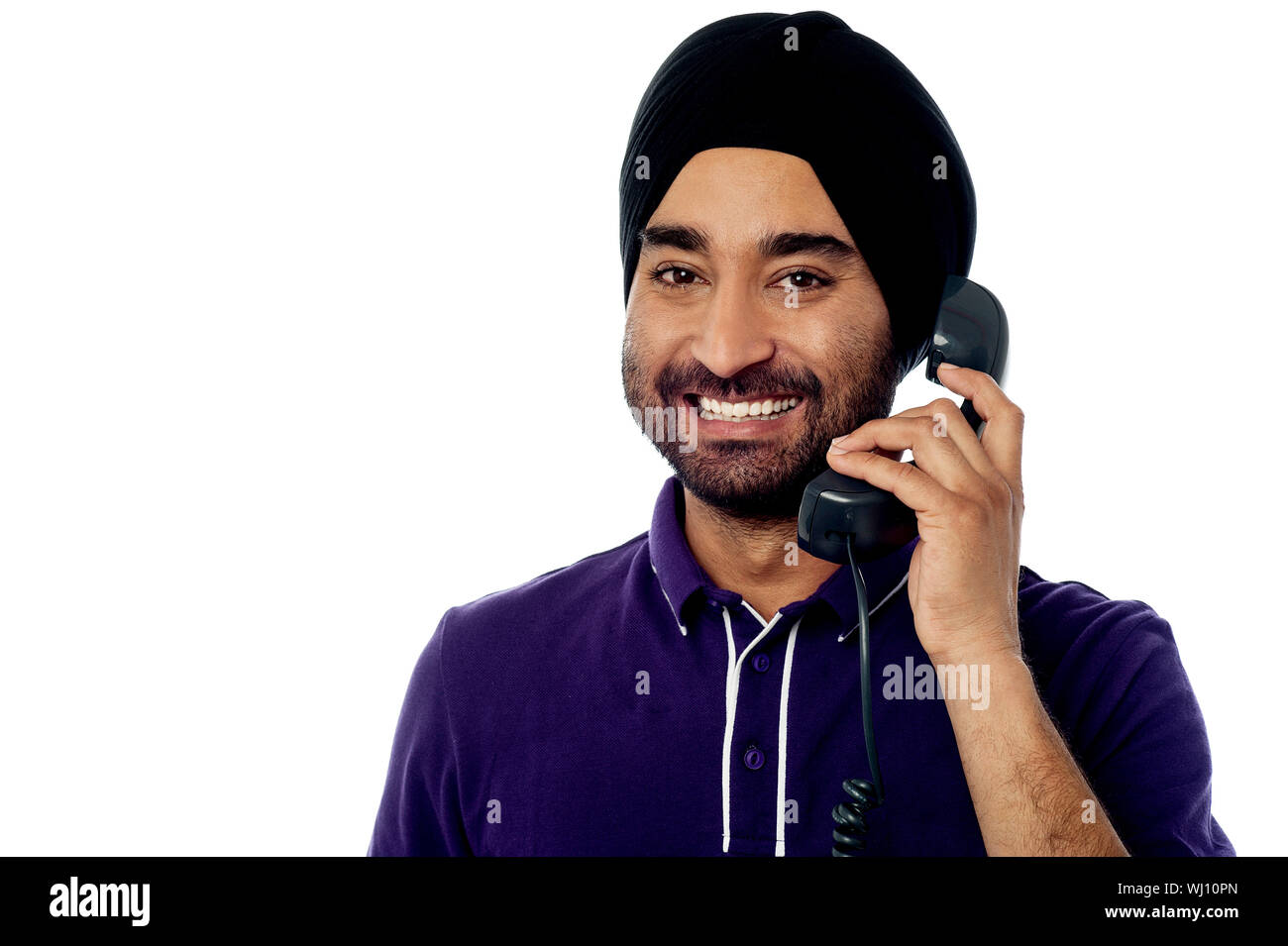 Handsome young guy attending phone call Stock Photo