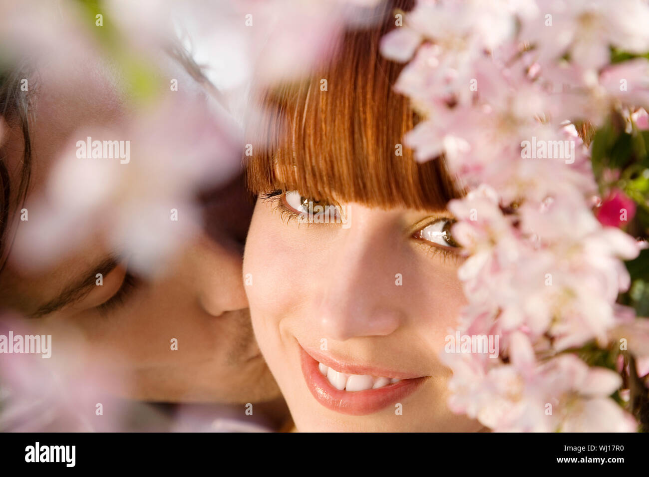 Couple kissing at blooming tree hi-res stock photography and images - Alamy