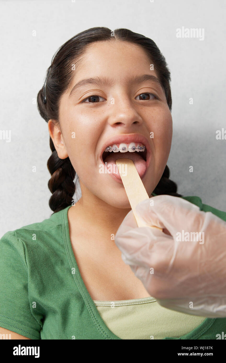 Nurse checking girls tongue in hospital Stock Photo Alamy