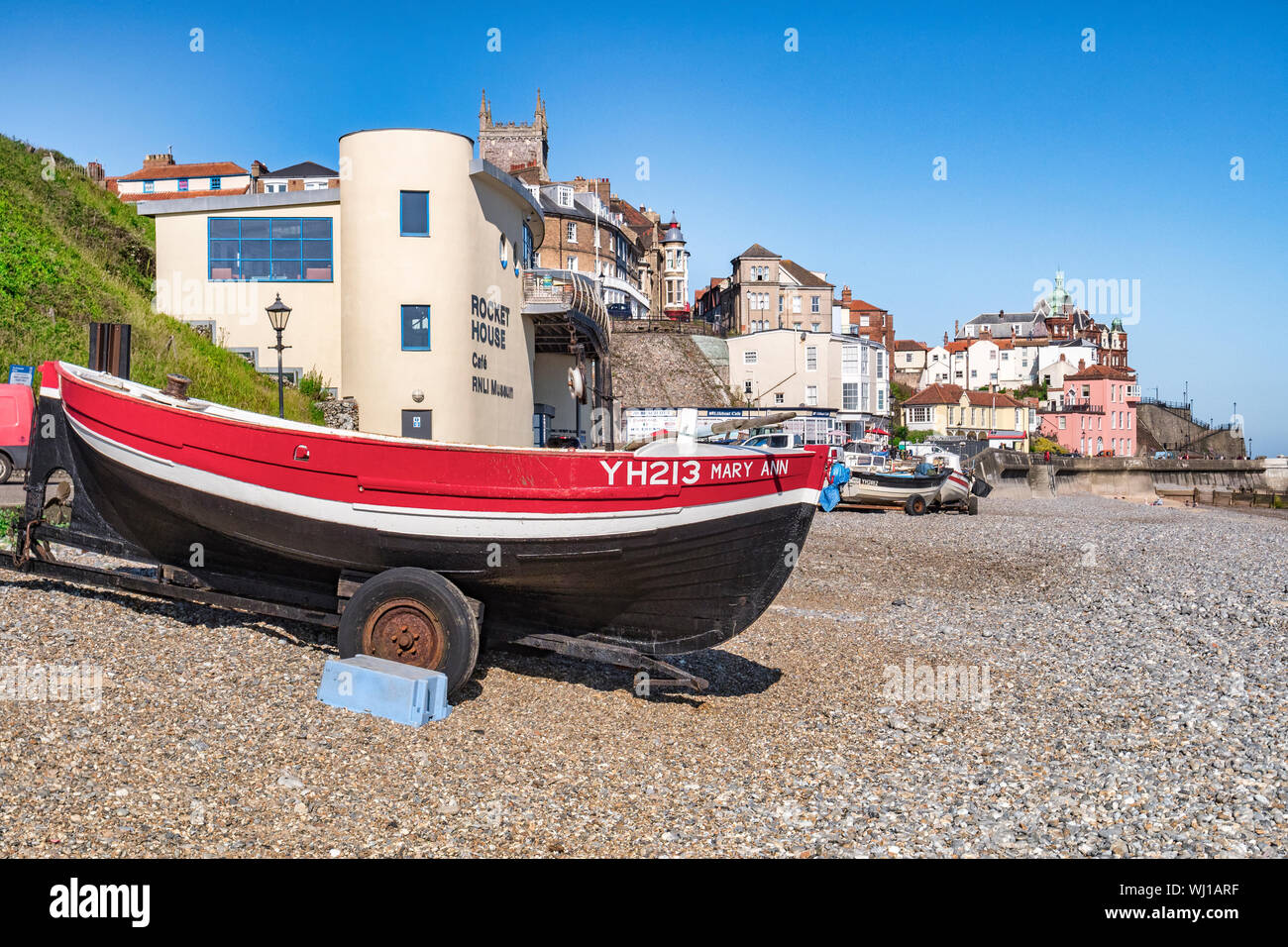 30 June 2019: Cromer, Norfolk, UK - The beach at Cromer, Norfolk, with boats on trailer and the RNLI Museum. Stock Photo