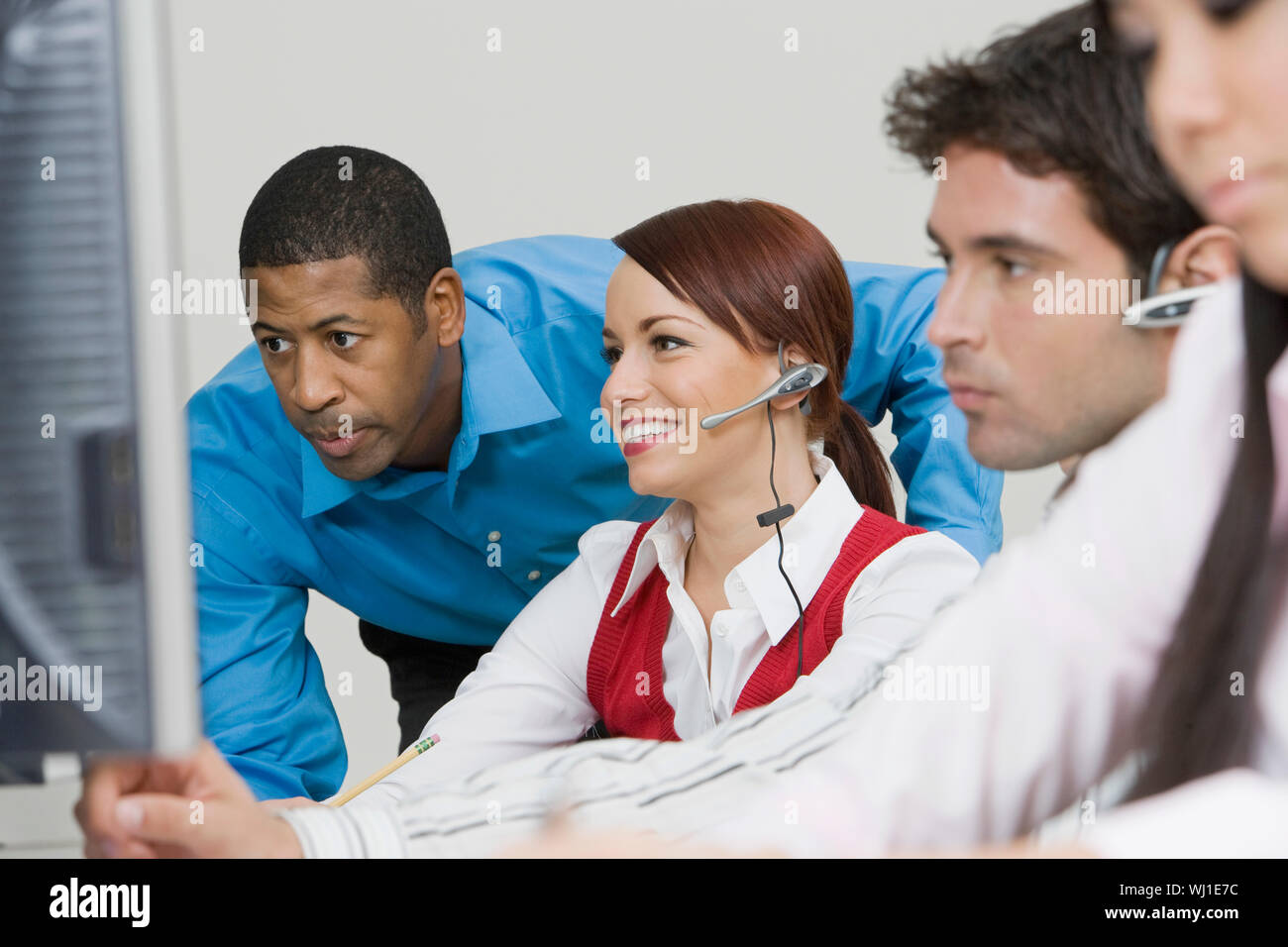 Businesspeople wearing headsets in the office Stock Photo