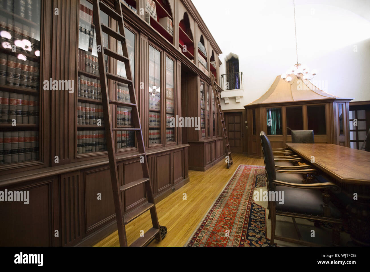 View Of Empty Table And Chairs By Bookshelf In An Old Fashioned