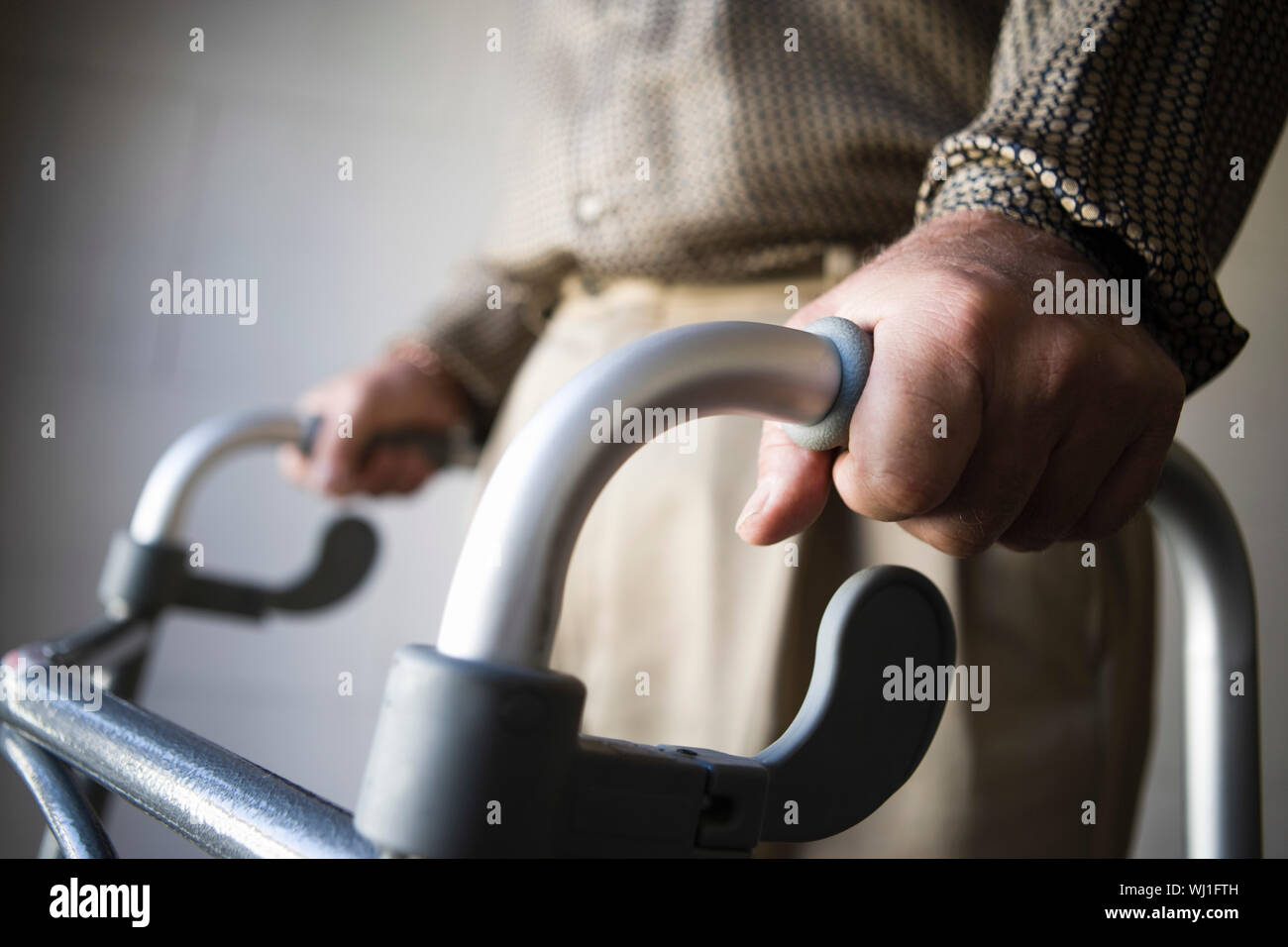 Closeup midsection of a man using walking frame Stock Photo