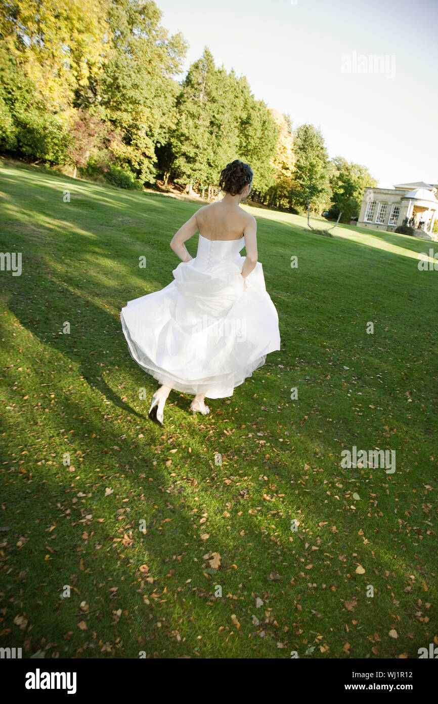 Woman running rear view park dress hi-res stock photography and images ...