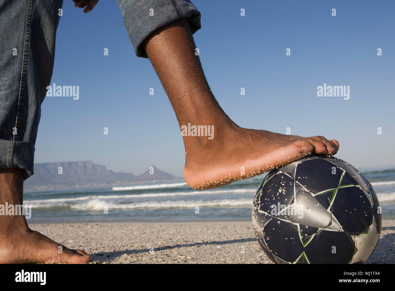 Closeup side view of barefeet with soccer ball at beach Stock Photo - Alamy