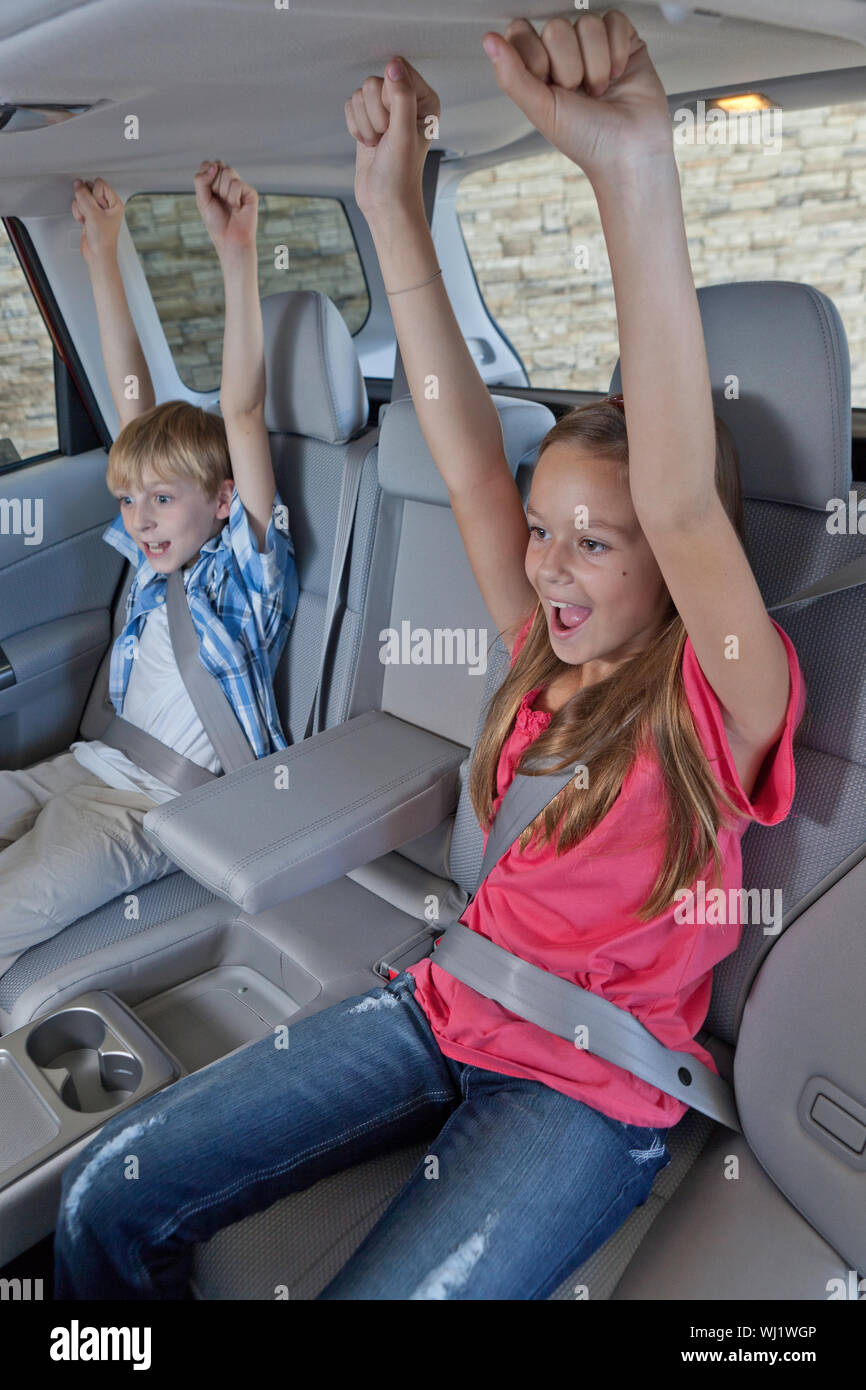 Cheerful children sitting at the back seat of car Stock Photo - Alamy