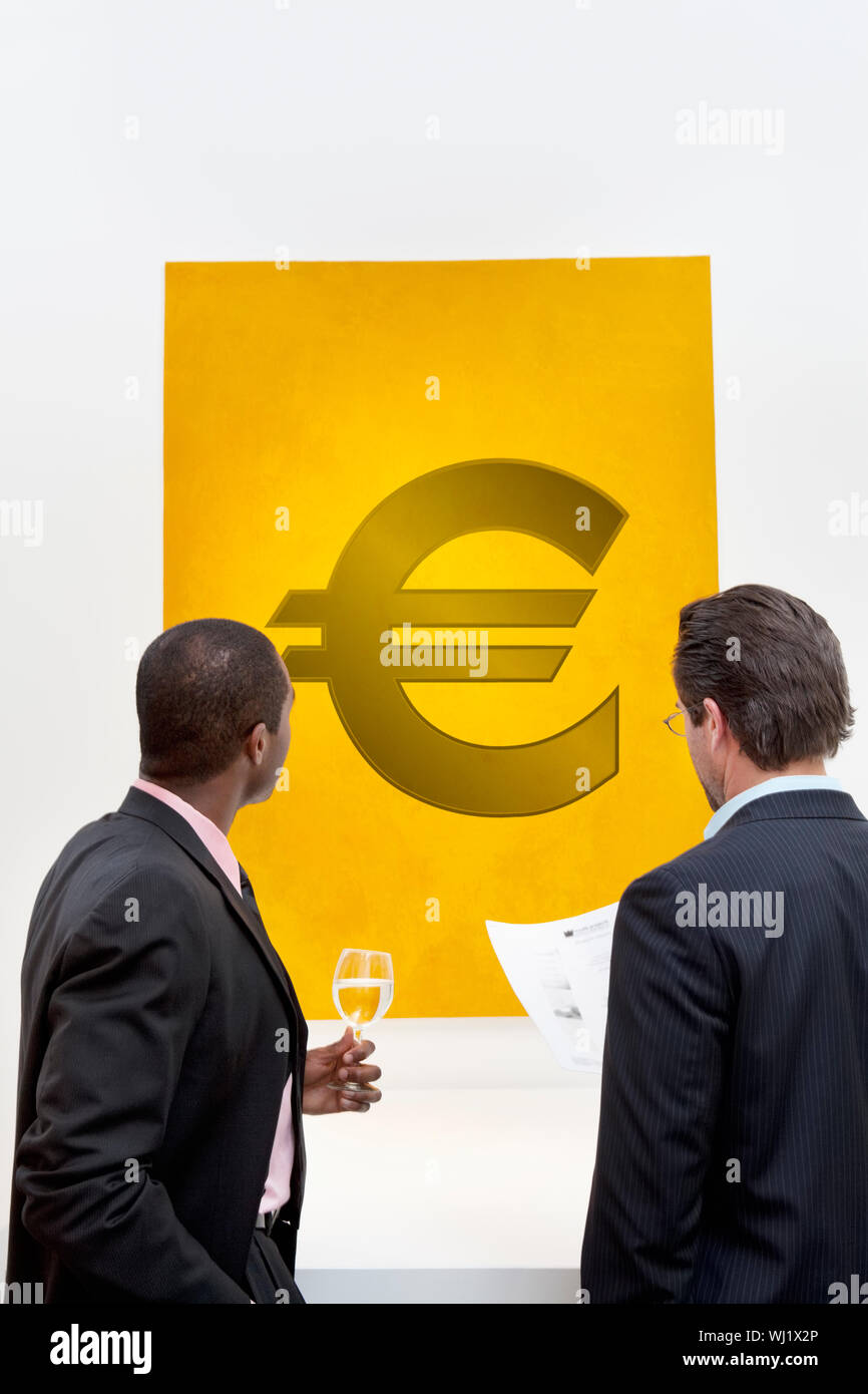 Male executive looking at Euro sign over white background Stock Photo ...