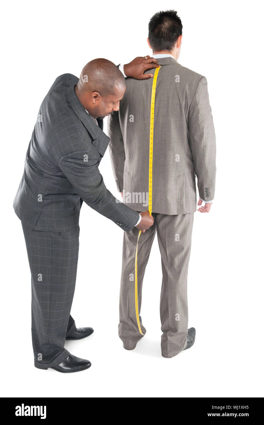 Male tailor fitting a man with a suit over white background Stock Photo
